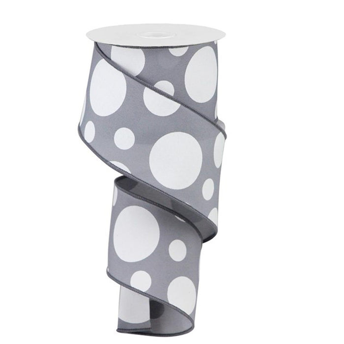 The 2.5 Dark Grey White Giant Three Size Dot Ribbon RGA1935NX, partially unwound and coiled, features large white polka dots and wraps around a white cardboard spool.