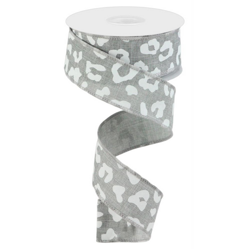 The 1.5 Grey White Animal Print Ribbon RGC140310 features a gray and white leopard pattern with a spiral design, a polyester wired edge for structure, and comes on a sleek white spool.
