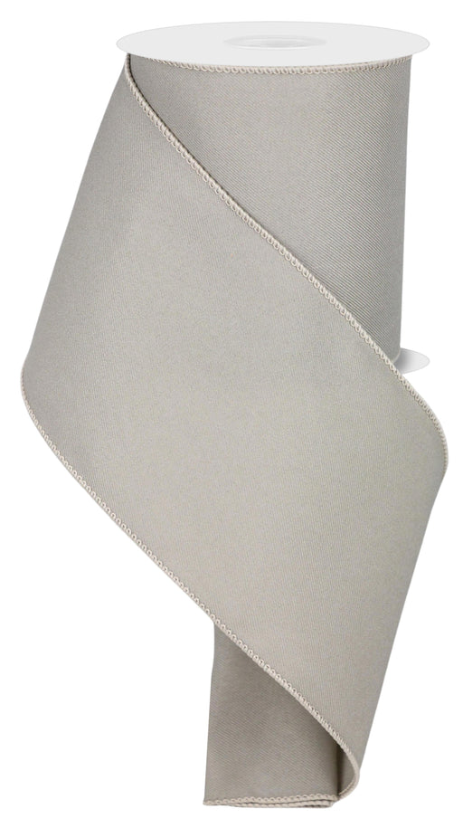 The 4X10Yd Diagonal Weave Fabric Taupe RGE1204LR ribbon artistically spirals around itself with stitched edges and is elegantly displayed vertically on a white background.