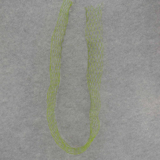 The 6 by 3.75 Wide Ribbon Wire With Moss (SA7057) is shown as a green, flexible mesh tube arranged in an open loop on a plain gray background.