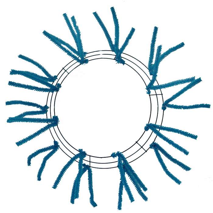 The Pencil Wreath Turquoise Non-Metallic 24 XX750441 features a circular wire frame with evenly spaced blue pipe cleaners extending outward like sun rays, creating a striking, minimal, and symmetric design.