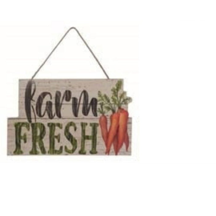 The Wood Vegetable Wall Decor Assorted A1666 is a wooden farmhouse sign featuring "farm FRESH" in black and green, three orange carrots with green tops, and hangs by a string—a delightful kitchen wall accent.