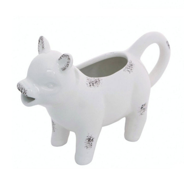 The Farm Animal Creamer Assorted A2536 is a whimsical white ceramic cow creamer with gray speckles, featuring a back opening, mouth spout, and tail-shaped handle for both charm and functionality.