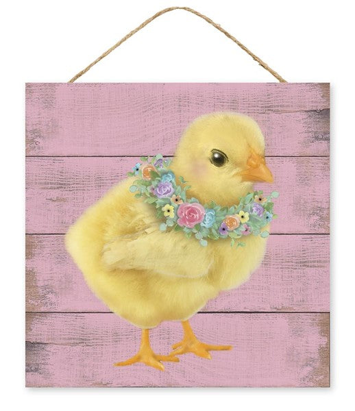 A 10 square sign features a yellow chick with a floral wreath against a pink wooden backdrop, complete with a rope hanger.