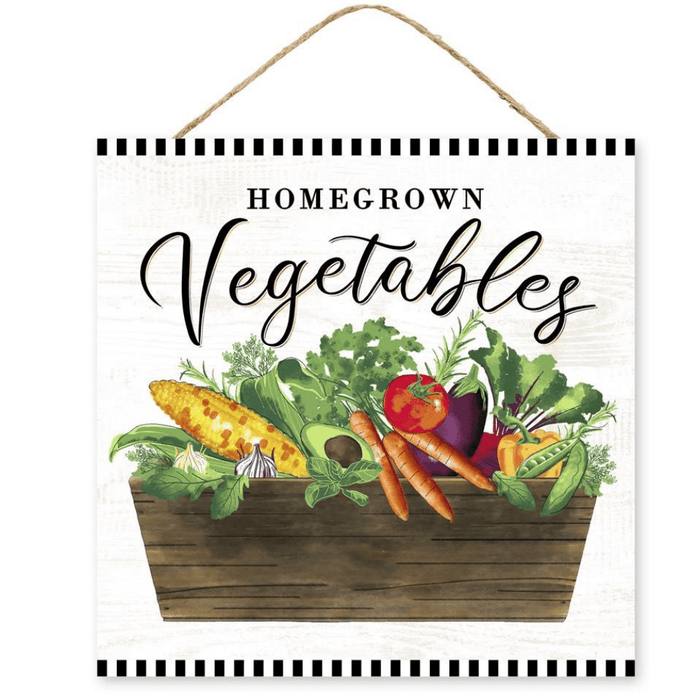 An illustration of a wooden basket overflowing with vibrant vegetables like corn, carrots, tomatoes, garlic, and greens. Homegrown Vegetables is written in elegant script on the rustic MDF 10 Homegrown Vegetable Sign AP7100 with a hanging rope.