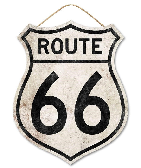 The 12H x 9.5W Vintage Rt 66 Badge Sign (AP7118) features bold black lettering on a light tan/black shield-shaped background with visible weathering and a string at the top for hanging.
