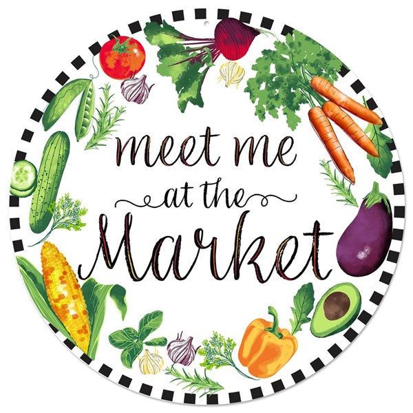 The 12Dia Meet Me At The Market Metal Sign (MD0697) features a black and white border and vibrant illustrations of tomatoes, beets, carrots, eggplants, and herbs surrounding the text in green/yellow/orange/purple/red.