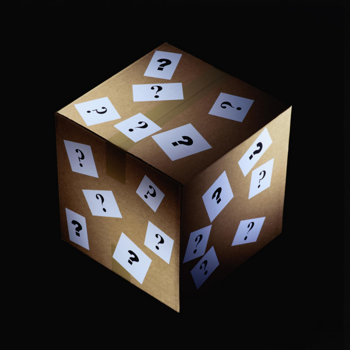 The Live Sale Mystery Box 06192025, wrapped in white paper with black question marks, stands out against a dark background—ideal for your next live sale or for stocking up on mystery supplies.