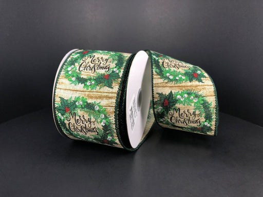 Two rolls of 2.5X10Y Natural Wood Linen/Wreaths-Merry Christmas ribbon (71193-40-15), featuring green wreaths, red berries, and festive text on a wood-patterned background, displayed on a plain black surface.