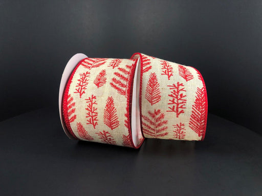 Two rolls of Ivory Canvas/Red Fern-Holly Branches 2.5X10Y Ribbon (71177-40-12) lie on their sides against a dark background, showing cream synthetic material with red pine-like holiday patterns.