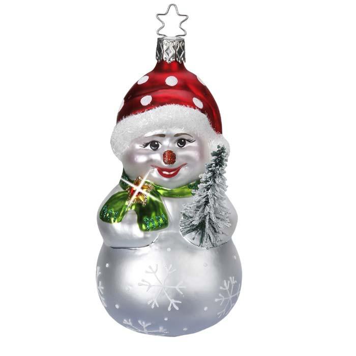 The Snowy Friend Limited Edition Snowman Ornament by Inge-Glas (1-004-15) has a smiling snowman in a red polka dot hat, green scarf, glittery tree, and silver body with snowflakes, inspired by mouth-blown glass ornaments.