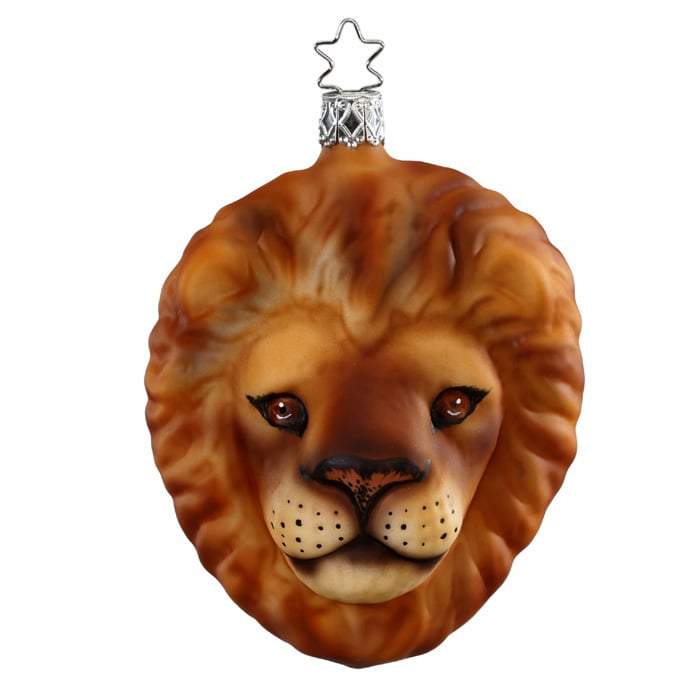 The Lion Kingdom Christmas Ornament Inge-Glas 1-099-16 is a handmade, mouth-blown glass ornament from Germany, featuring a realistic lion’s face with a metallic star-shaped hook for hanging.