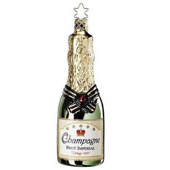 The Brut Champagne Inge-Glas Christmas Ornament (1-119-09) is a German mouth-blown glass piece shaped like a champagne bottle with gold foil, a red jewel, star-shaped loop, and "Champagne Brut Imperial Vintage 1937" label. A collectible holiday accent.