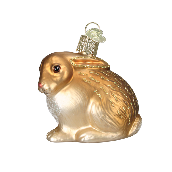 The Cottontail Bunny 12192 Old World Christmas Ornament Assorted is a hand-painted glass bunny with glitter accents and a hanging loop, shown shining against a plain white background.