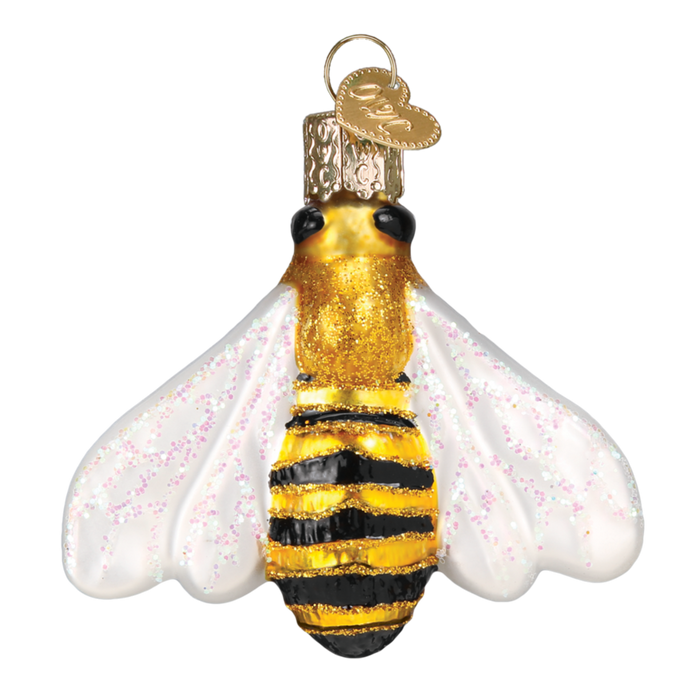 The Honey Bee 12520 Old World Christmas Ornament is a mouth-blown glass bee with white wings, gold glitter, black and yellow stripes, and a gold cap featuring a small round tag.