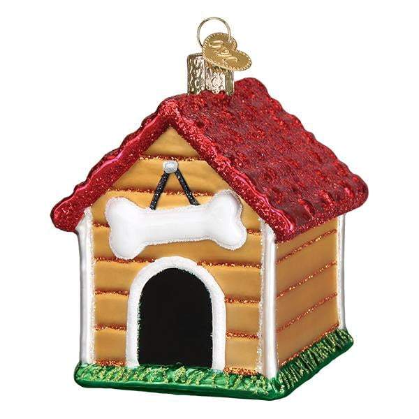 The Dog House 20113 Old World Christmas Ornament is a hand painted glass decoration with a red glittery roof, white bone above the arched doorway, and green grass at the base.