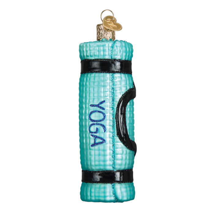 The Yoga Mat 32314 Old World Christmas Ornament features a turquoise mat with black straps, a handle, "YOGA" in blue letters, and a gold loop for hanging—perfect for any Old World Christmas collection.