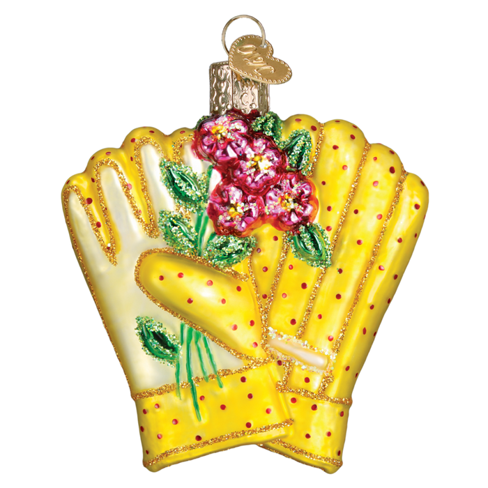 The Gardening Gloves Old World Christmas Ornament 32329 features yellow gloves with red polka dots holding pink flowers and includes a gold metal loop on top for hanging as a festive Christmas ornament.