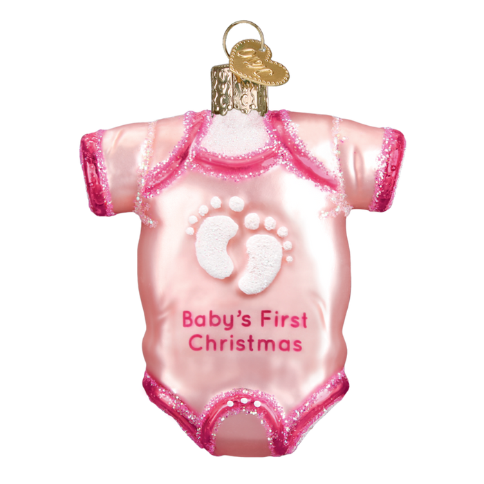 The Pink Baby Onsie Old World Christmas Ornament 32338 is hand-painted with glittery trim, white footprints, and the text Babys First Christmas. It features a gold cap on top for easy hanging.