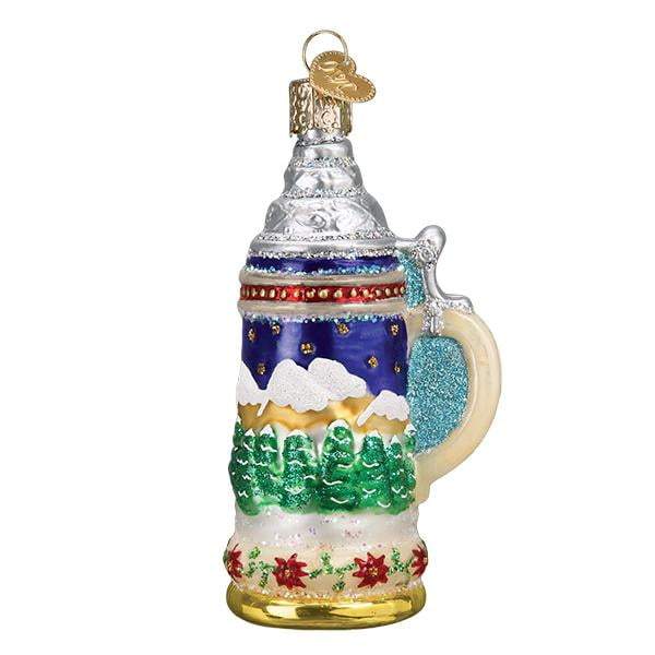 The German Stein 32369 Old World Christmas Ornament is a mouth-blown glass stein mug featuring snowy mountains, green trees, red poinsettias, glittery accents, and a gold hanging loop.