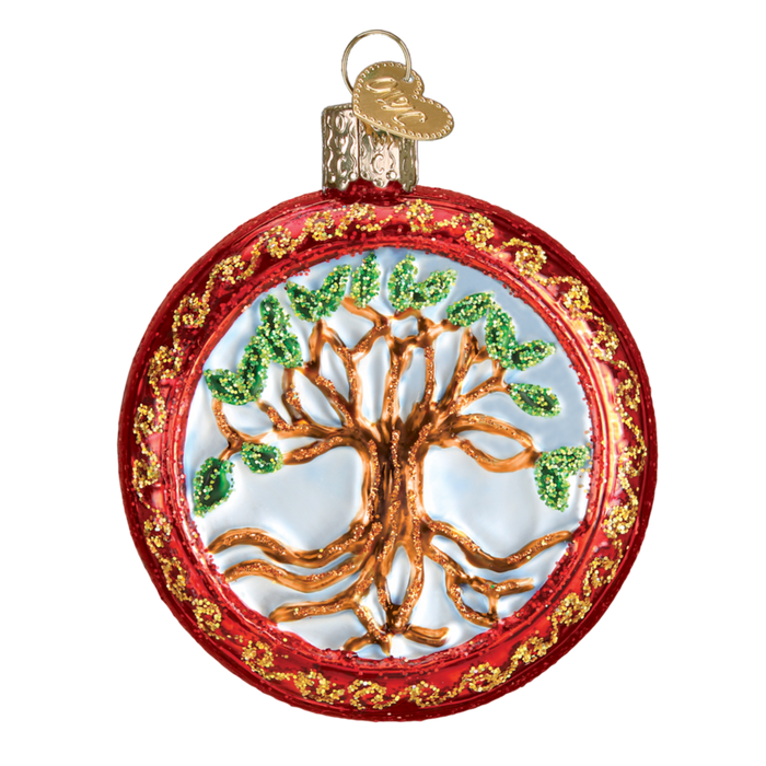 The Tree of Life 36233 Old World Christmas Ornament is a round, hand-painted glass ornament in gold and green with red and gold borders. It features a gold cap topped with a small gold heart charm.