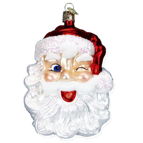 The Winking Santa 40114 Old World Christmas Ornament features Santa’s face with a red hat, white beard, rosy cheeks, and a playful wink, capturing holiday cheer in classic Old World Christmas glass style.