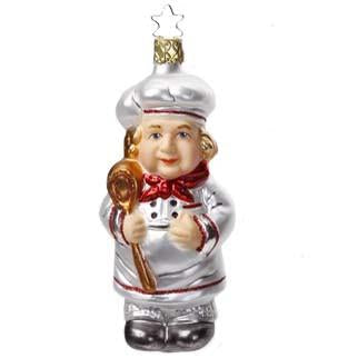 The Le Maitre The Chef Christmas Ornament by Inge-Glas of Germany (68245) features a hand-painted glass chef in a white hat and red-trimmed coat holding a spoon, finished with a gold star hanging loop.
