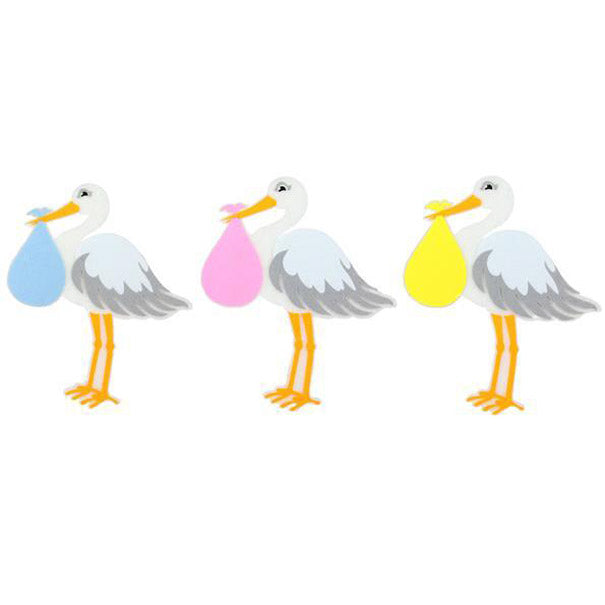 Three cartoon storks stand in a row on a white background, each holding a colored bundle—blue, pink, or yellow. The Assorted Stork Ornament MS156899 is crafted from foam and felt for a charming touch and comes in assorted colors.