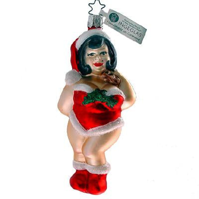 The Dressed to Thrill Santa Cutie Christmas Ornament by Inge-Glas of Germany (68435) features a smiling woman with dark hair in a red Santa hat, red dress with white trim, boots, and green decoration—classic German holiday charm.