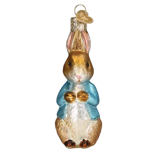 Inspired by Beatrix Potter's cherished character, the Peter Rabbit Ornament Old World Christmas 12686 features exquisite craftsmanship with a rabbit adorned in a light blue jacket, detailed fur texture, and a shiny finish. Ideal for holiday decorations, it comes with a gold loop for easy hanging.