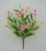 The 19 Pink Mini Flower Leaf Bush 32025-PK showcases a fan-shaped bouquet of pink mini flowers, their vibrant petals with yellow centers beautifully balanced by lush green leaves and stems, all set against a plain light background.