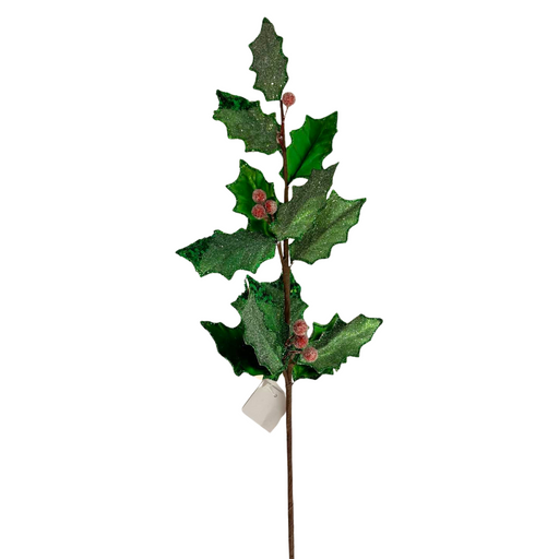 The 27" Green and Red Metallic and Sugared Holly Leaves and Berries Spray 32231 showcases emerald green leaves with a glossy, glittery finish and small red berries, all attached to a brown stem adorned with a white tag at the base.