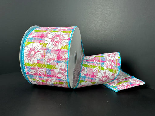 A partially unrolled roll of 2.5X10Y Pink Fuchsia Lime Aqua Satin Plaid White Gerberas Ribbon (41525-40-39) features a floral pattern in pink, white, and green against a dark background.