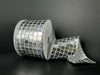 A roll of 2.5X10Y Silver Discoball Sequins Ribbon (41533-40-16) sits against a dark background, partially unrolled to reveal its shiny, mirror-like surface with a grid of silver squares, reminiscent of a disco ball.
