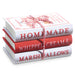 The 8 Hot Cocoa Faux Book Stack (4316112) features three red and white books tied with string, with spines reading HOMEMADE, WHIPPED CREAM &, and MARSHMALLOWS—ideal for cozy hot cocoa decor.