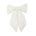 The 11" Ivory Velvet Bow Clip-on Ornament 4550510 features wide loops and long tails, perfect for festive décor or as a Christmas Shoppe accent, shown on a plain white background.