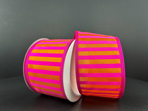 Two rolls of 2.5X10Y Fuchsia Satin-Orange Stripes/Orange Edge Ribbon (46426-40-19) rest on a dark surface, featuring a glossy texture and vibrant colors that create a striking contrast.