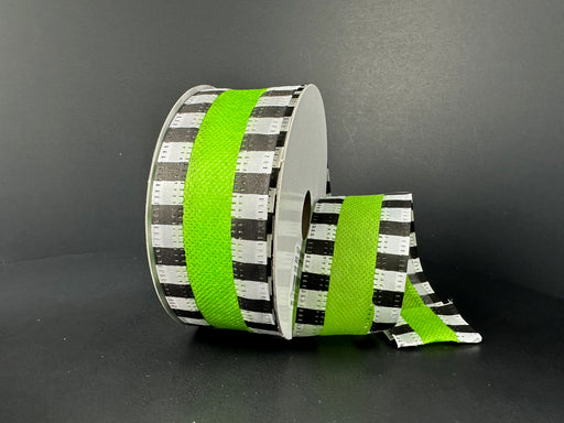 A partially unrolled 1.5X10Y Lime Flat Breeze/Black And White Stripe Edge Ribbon features a striking black and white checkered pattern with a bold bright green stripe edge, set against a plain dark background.