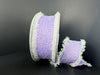 Against a black background, the 2.5X 5Y Lavender Iridescent Loopy Edge Ribbon (47509-40-30) is shown with frayed edges: one larger spool stands upright while the smaller lies beside it, displaying its soft woven texture.