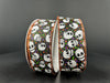 Two 1.5X10Y black satin ribbons, each adorned with white skulls, colorful dots, and edge-accented in orange stitching, are arranged against a dark background.