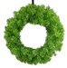 The 24 Green Tinsel Wreath (Product code: 57197WR24) features lush, textured foliage arranged in a symmetrical circle. Its soft, bright green appearance makes it ideal for festive or decorative use, with a plain backdrop that enhances its charm.