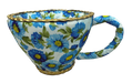 The 4H X 6W Blue Tea Cup Ornament (63725BL) showcases a uniquely shaped teacup with a wide opening, featuring a vibrant blue and green floral pattern with a gold braided design on the rim and handle for added elegance.