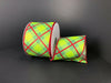 Two rolls of the 2.5X10Y Green-Red Georgina Plaid ribbon, featuring green, blue, and yellow patterns with red edging on a black background, are displayed with one roll upright and the other leaning elegantly.