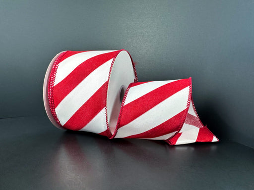 Two rolls of 2.5X10Y Red Satin/White Glass Big Candy Cane Stripe Ribbon (72540-40-12), featuring red and white diagonal stripes, are displayed on a dark background—one upright, the other partially unrolled to reveal the festive design.