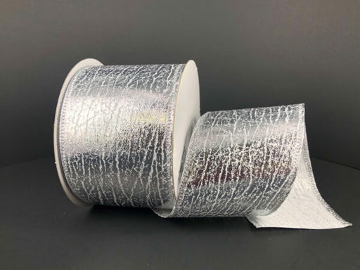 A partially unrolled spool of 2.5X10Y Silver Crackle Lame Ribbon (75206-40-16) with a wide, metallic silver, crackle-textured design is displayed against a plain dark background.