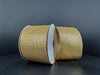 Two spools of 2.5X10Y Gold Stairstep Woven Metallic 76310-40-15 ribbon sit side by side against a dark background, their metallic surfaces showcasing detailed textured patterns.
