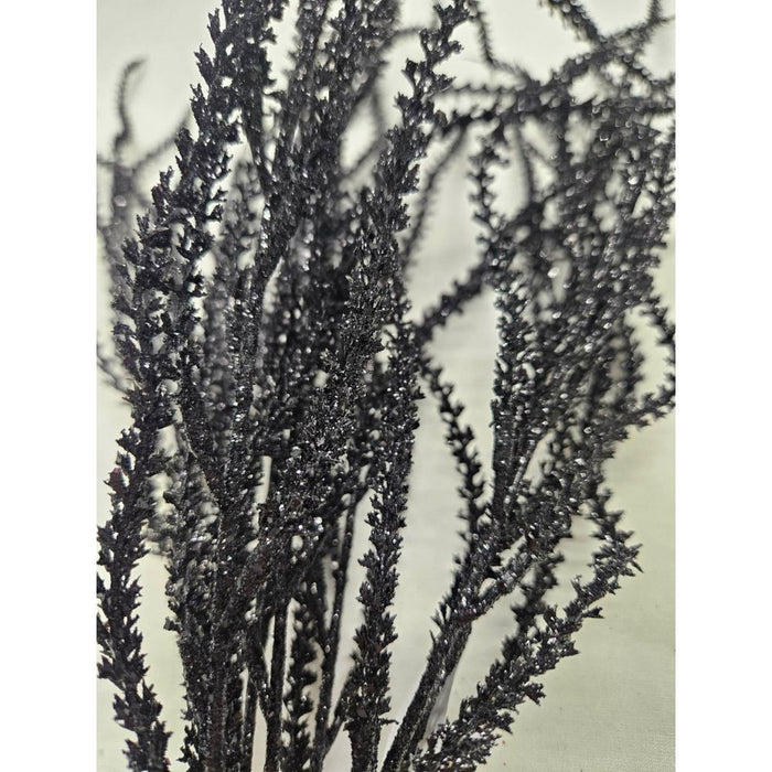 Close-up of several 22 Black Willow with Glittered 82841-BK branches standing upright against a light background, showcasing their textured surfaces and sparkling glitter details.