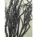 Close-up of several 22 Black Willow with Glittered 82841-BK branches standing upright against a light background, showcasing their textured surfaces and sparkling glitter details.