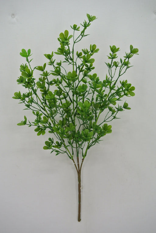 A 19 Plastic Bush with 7 stems (84063) features a realistic artificial green plant branch on a plain white background, adorned with numerous small, vibrant green leaves.