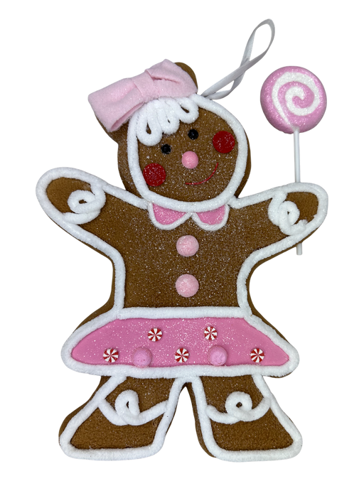 The H10xW8.5xD1.5 Brown and Pink Gingerbread Girl Ornament 86498BNPK features white icing details, a pink bow and skirt with buttons, a happy expression, holds a pink swirl lollipop, and includes a loop for easy hanging.